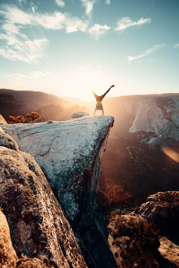 man-doing-hand-stand-on-mountain-2387866-683x1024